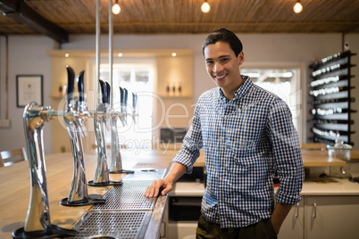 Smiling man at counter in restaurant