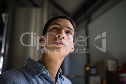 Thoughtful manager standing in warehouse