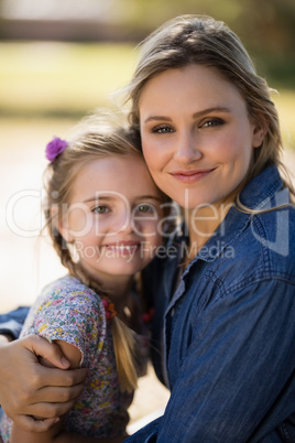 Mother and daughter embracing each other in park