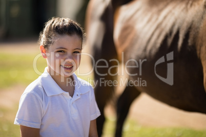 Portrait of smiling girl standing in the ranch