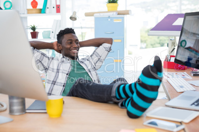 Male executive relaxing at his desk