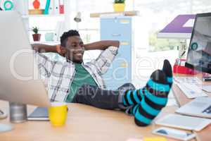 Male executive relaxing at his desk