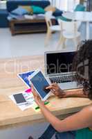 Female executive using digital tablet at desk