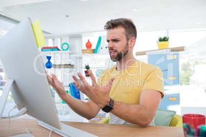 Depressed male executive working on computer