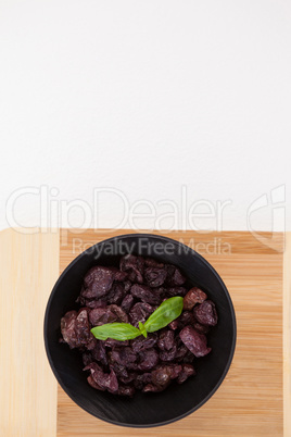 Overhead view of dried olives on cutting board