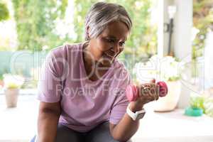Close up of senior woman exercising with dumbbell