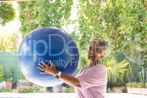 Portrait of woman holding fitness ball