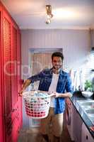 Portrait of man holding laundry basket
