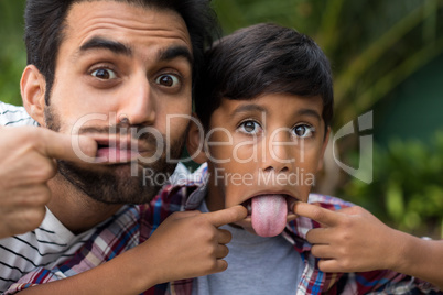 Portrait of father and son teasing