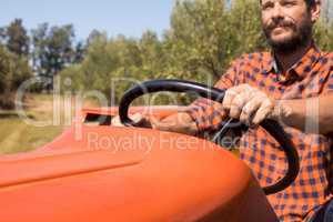 Man driving tractor in olive farm