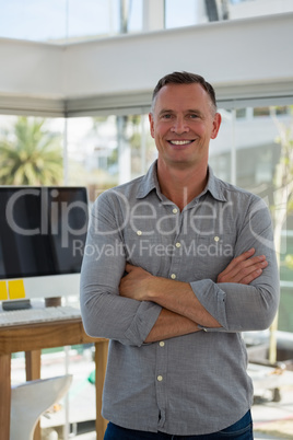 Portrait of confident businessman standing at studio