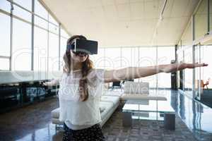 Smiling businesswoman using virtual reality simulator exercising in office