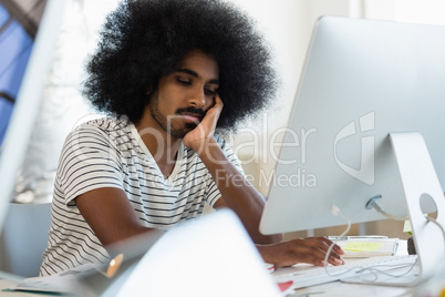 Man using computer at desk in office