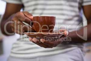 Midsection of man having coffee