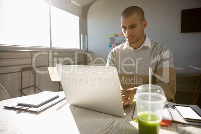 Man working in office on sunny day