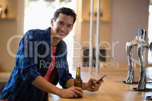 Man using mobile phone at counter