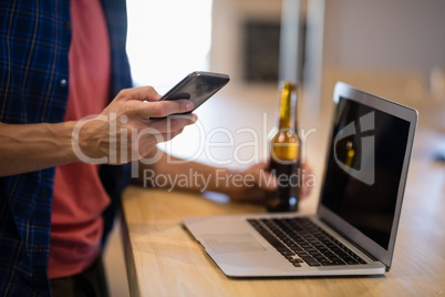 Man using mobile phone at counter