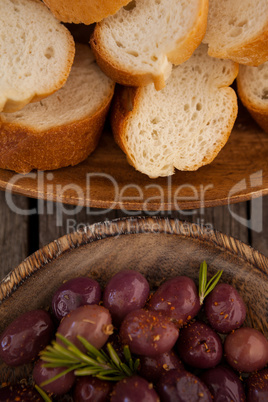 Overhead view of olives and bread in plates