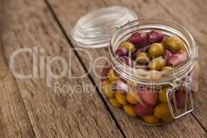 Close up of olives with oil in glass jar