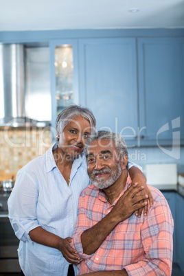 Portrait of smiling couple with arm around