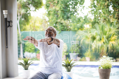 Senior man exercising in yard