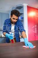 Man cleaning wooden table
