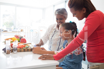 Multi-generation family using digital tablet in the kitchen