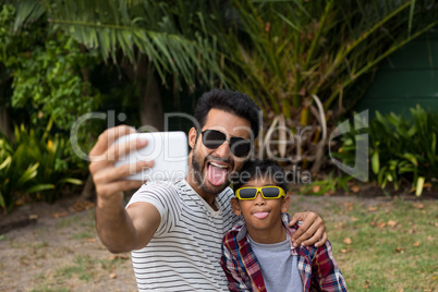Playful father and son taking selfie