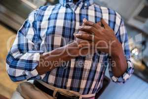 Midsection of man with hand on chest suffering from chest pain