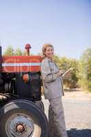 Portrait of happy woman using digital tablet in olive farm