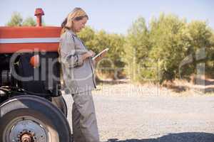 Woman using digital tablet in olive farm