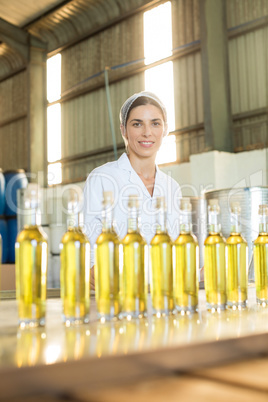 Portrait of happy worker standing at table