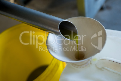 Olive oil being produced from machine
