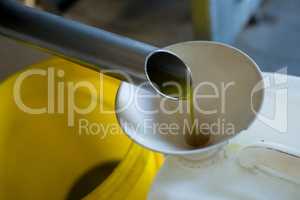 Olive oil being produced from machine