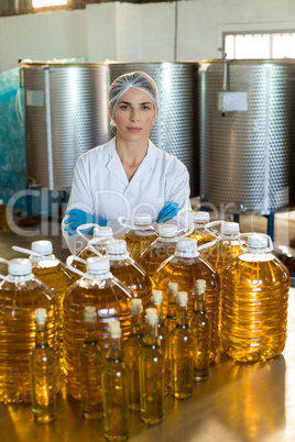 Portrait of confident female technician standing with arms crossed