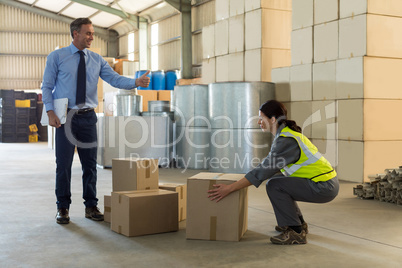 Manager instructing female worker while working