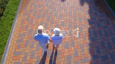 Aerial footage of senior couple walking outdoors in park