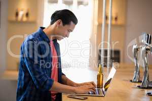 Man using laptop at counter