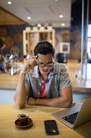 Man using laptop in restaurant