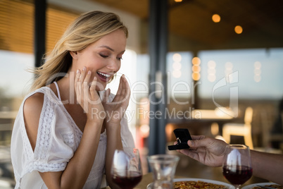 Man giving engagement ring to surprised woman