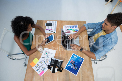 Male and female executives working in the office