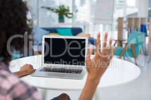 Female executive working on laptop at desk