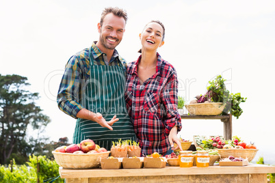 Portrait of happy couple selling organic vegetables