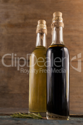 Close up of olive oil in bottles with herb
