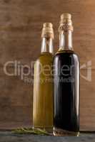 Close up of olive oil in bottles with herb