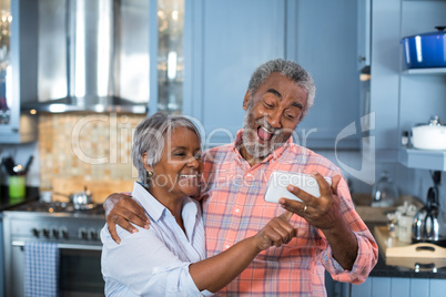 Couple taking selfie at home