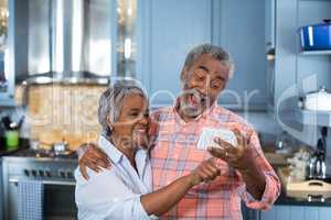 Couple taking selfie at home