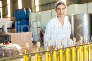Portrait of happy worker standing at table