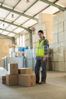 Portrait of female worker standing near boxes