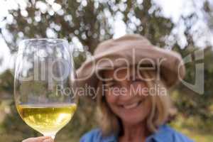 Smiling woman standing with a glass of wine